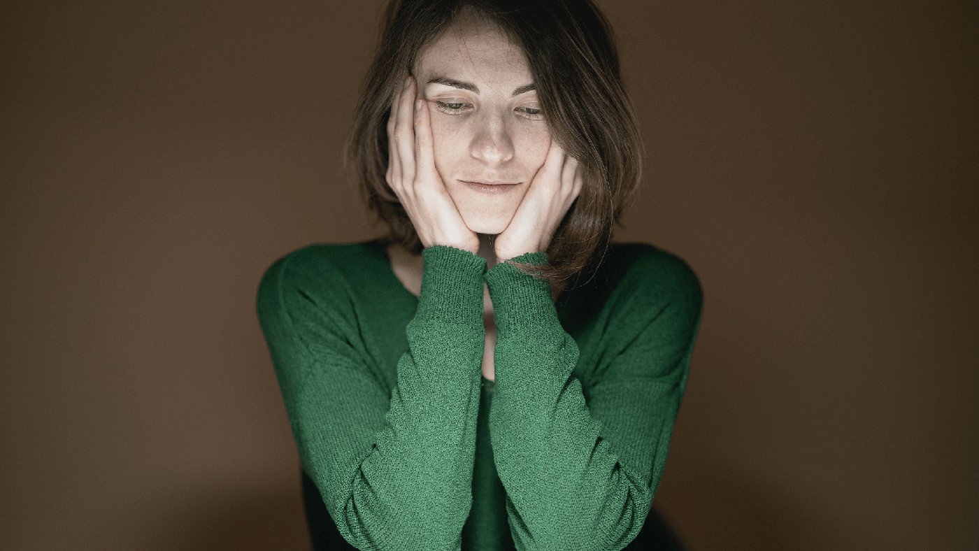 woman in green sweater upset because her military sexual trauma claim was denied